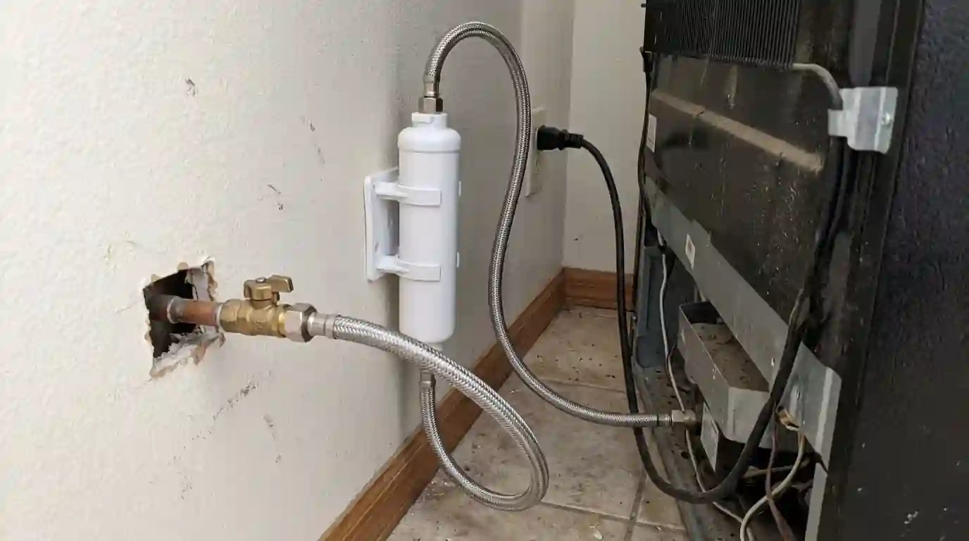 Braided water line and valve behind a refrigerator